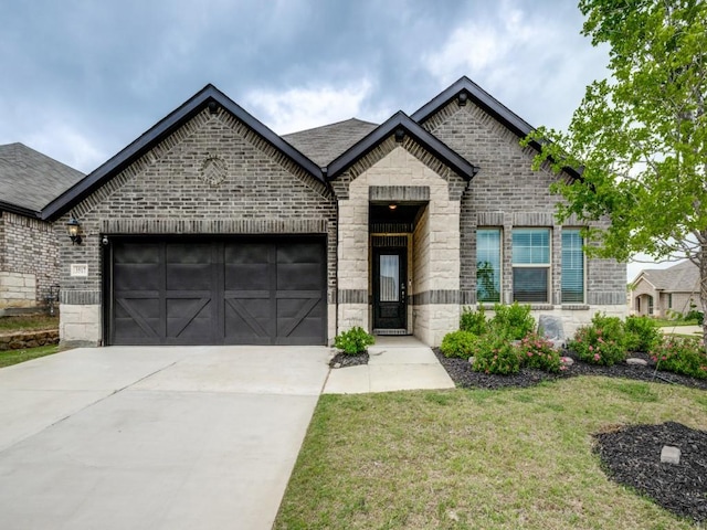 3517 Triumph Dr, Denton, TX 76207 - french provincial home featuring a front yard, stone siding, brick siding, an attached garage, and driveway