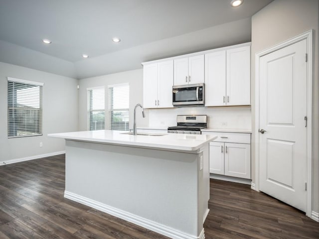 3517 Triumph Dr, Denton, TX 76207 - kitchen with appliances with stainless steel finishes, a sink, a kitchen island with sink, white cabinetry, and dark wood-style floors