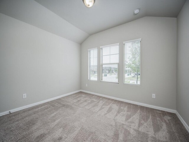 3517 Triumph Dr, Denton, TX 76207 - unfurnished room featuring baseboards, vaulted ceiling, and carpet