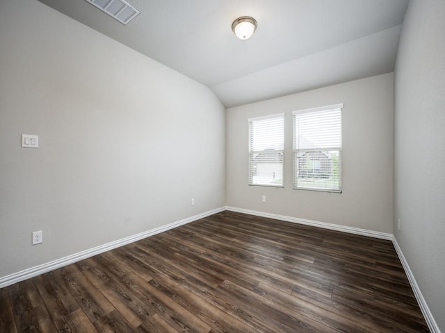 3517 Triumph Dr, Denton, TX 76207 - empty room featuring visible vents, baseboards, dark wood-type flooring, and lofted ceiling