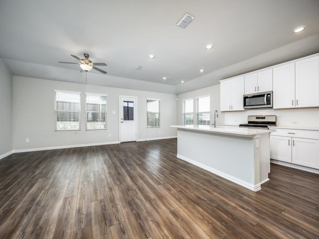 3517 Triumph Dr, Denton, TX 76207 - kitchen featuring open floor plan, dark wood finished floors, a ceiling fan, and stainless steel appliances