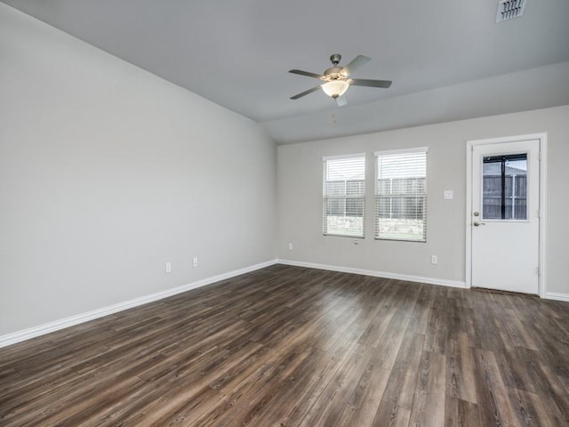 3517 Triumph Dr, Denton, TX 76207 - unfurnished living room featuring ceiling fan, dark wood-style flooring, visible vents, baseboards, and lofted ceiling