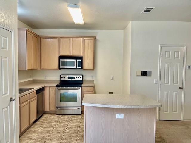 kitchen featuring visible vents, light countertops, appliances with stainless steel finishes, and light brown cabinetry