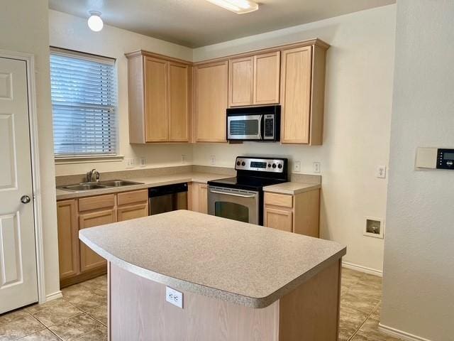 kitchen featuring light brown cabinets, light countertops, a sink, light tile patterned floors, and stainless steel appliances