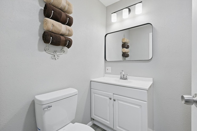 bathroom with toilet and vanity