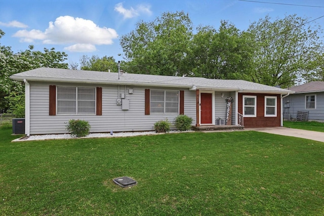 ranch-style home with central air condition unit and a front yard