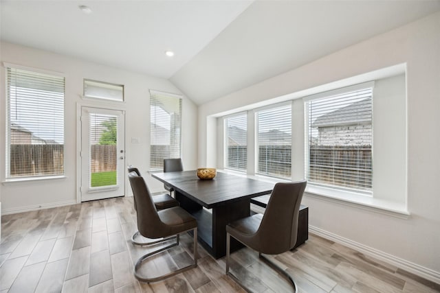 dining space with recessed lighting, baseboards, vaulted ceiling, and wood finished floors