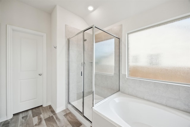 full bath with baseboards, a stall shower, and a bath