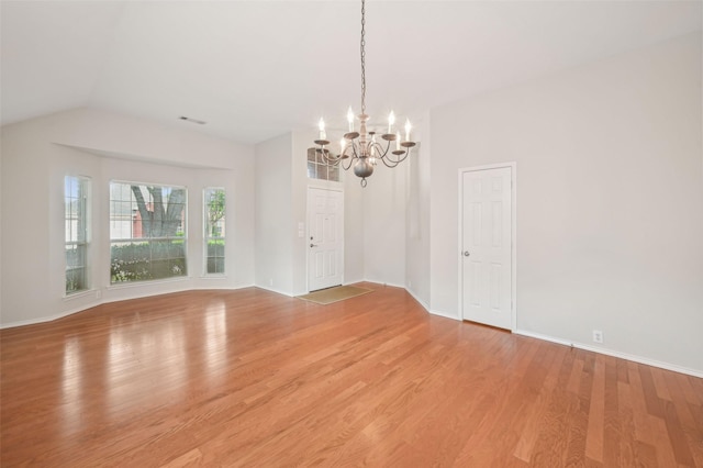 unfurnished room featuring light wood-style floors, baseboards, visible vents, and a chandelier
