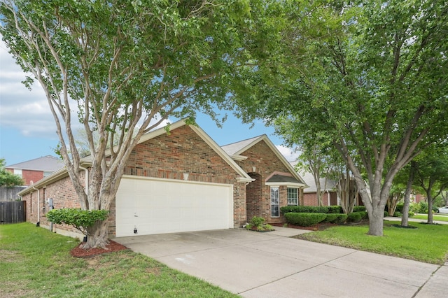 view of front of house with an attached garage, a front lawn, and brick siding