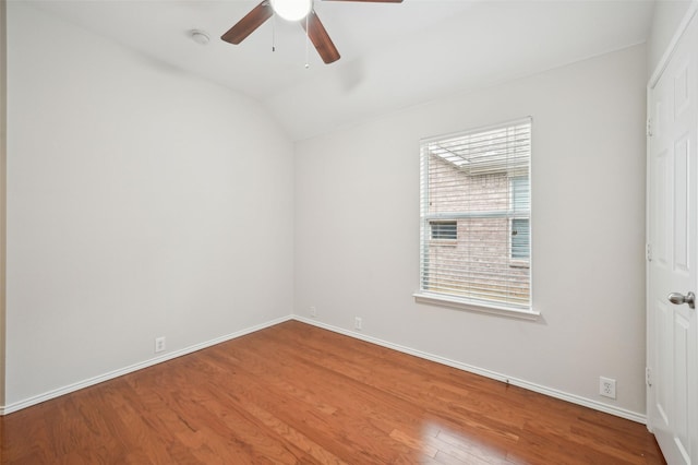 unfurnished room with baseboards, ceiling fan, wood finished floors, and lofted ceiling