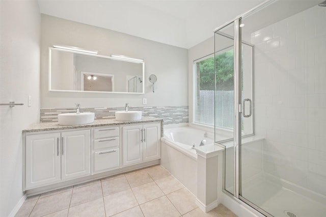 bathroom featuring a garden tub, a sink, and a stall shower