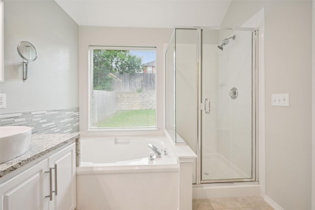 full bath featuring decorative backsplash, a bath, tile patterned flooring, a shower stall, and vanity
