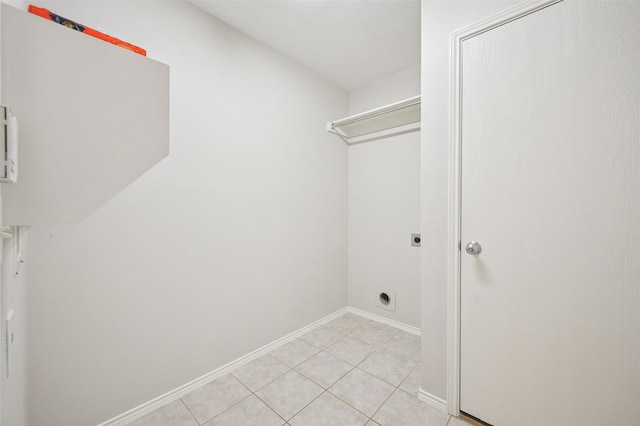 washroom featuring hookup for an electric dryer, laundry area, baseboards, and light tile patterned floors