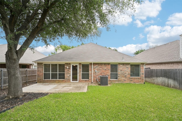 rear view of property featuring a patio, a fenced backyard, a lawn, and a chimney