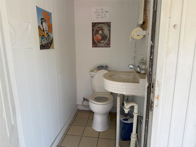 bathroom with toilet and tile patterned floors