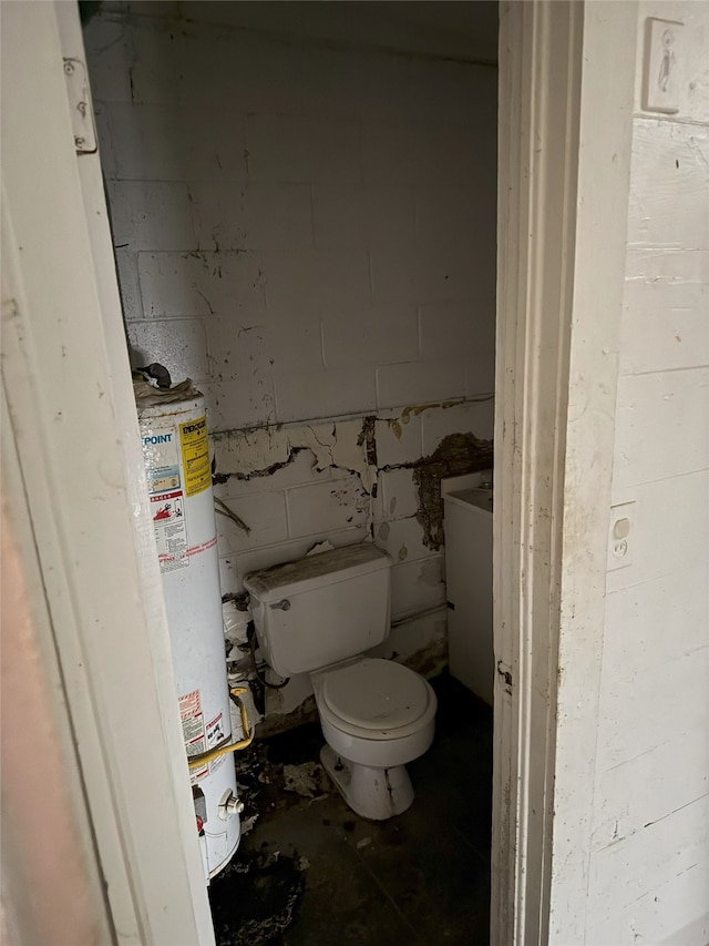 bathroom featuring water heater and toilet