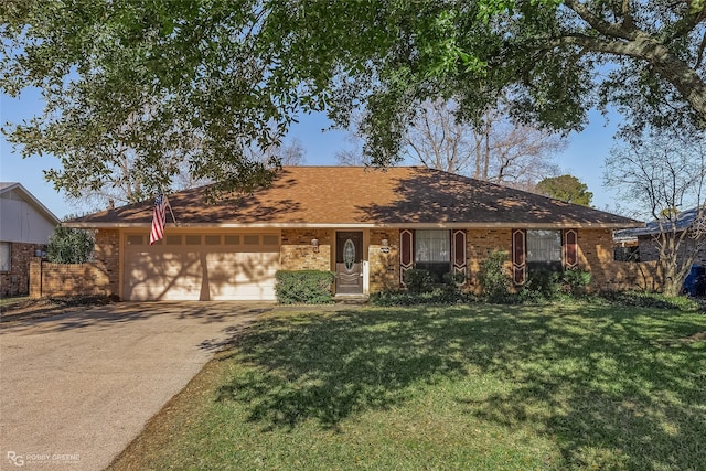 ranch-style house featuring an attached garage, a front yard, brick siding, and concrete driveway