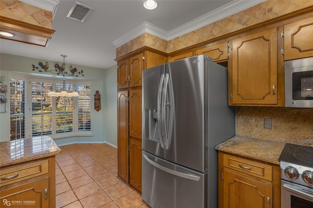 kitchen featuring brown cabinets, hanging light fixtures, stainless steel appliances, light tile patterned floors, and visible vents