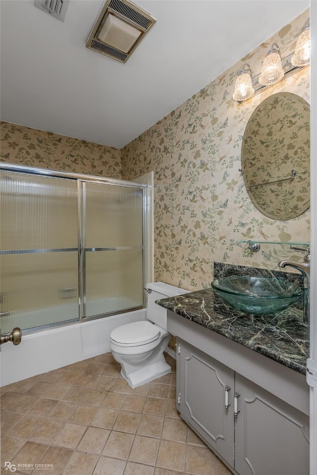 bathroom with visible vents, vanity, toilet, and wallpapered walls