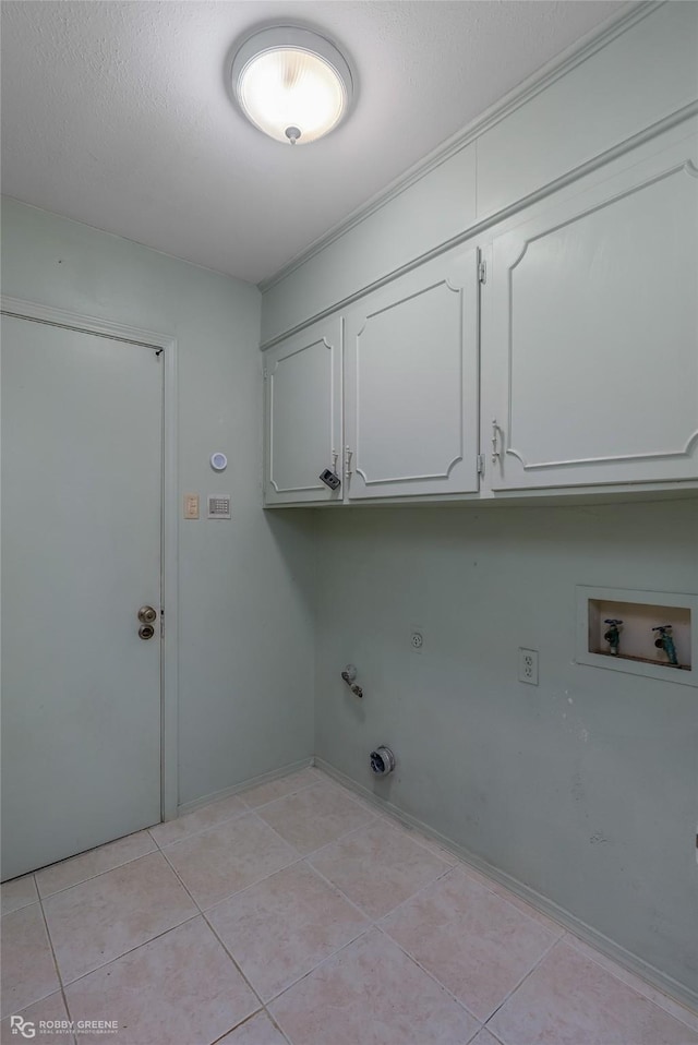 washroom featuring cabinet space, light tile patterned flooring, gas dryer hookup, and hookup for a washing machine