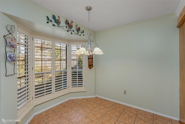 unfurnished dining area featuring baseboards, a notable chandelier, and light tile patterned flooring