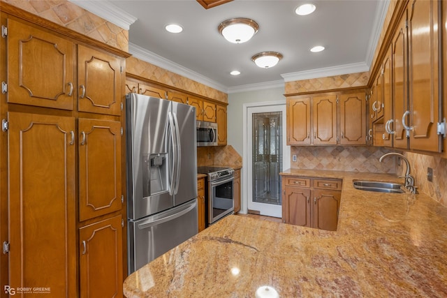 kitchen with a sink, decorative backsplash, appliances with stainless steel finishes, and brown cabinets