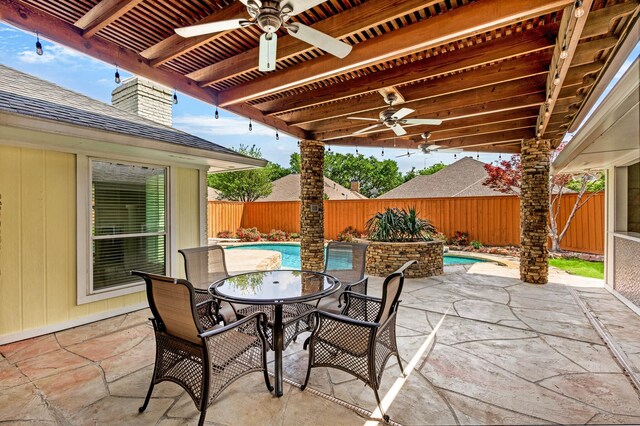 view of patio featuring ceiling fan, a fenced in pool, a fenced backyard, and outdoor dining space