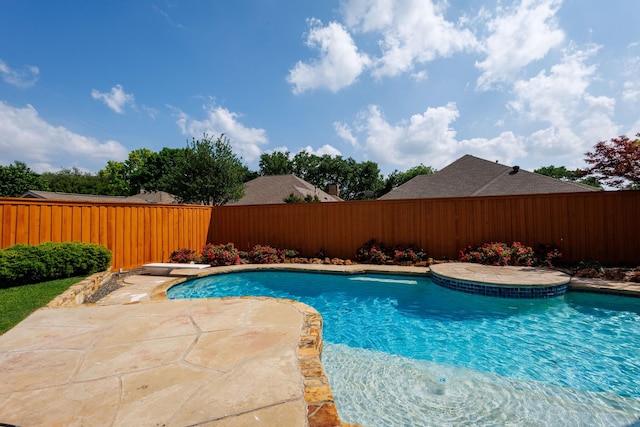 view of pool with a fenced in pool, a fenced backyard, a diving board, and a patio