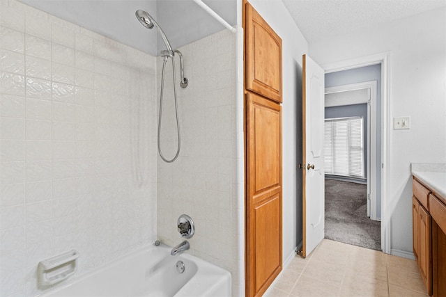 1013 Briarcreek Dr, Arlington, TX 76012 - full bath with vanity, a textured ceiling, tile patterned floors, baseboards, and shower / bath combination
