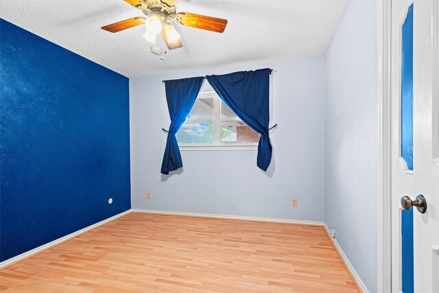1013 Briarcreek Dr, Arlington, TX 76012 - spare room with baseboards, ceiling fan, a textured ceiling, and wood finished floors