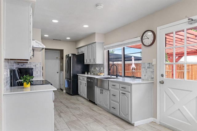 kitchen with a sink, appliances with stainless steel finishes, and light countertops
