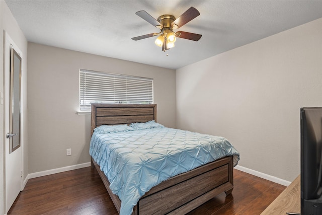 bedroom featuring baseboards, a ceiling fan, and wood finished floors