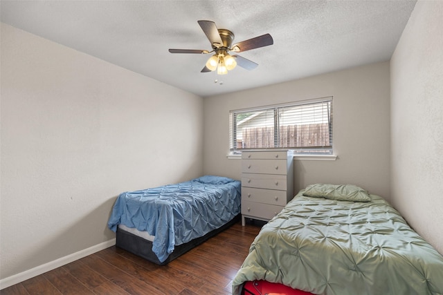 bedroom featuring a ceiling fan, baseboards, and wood finished floors