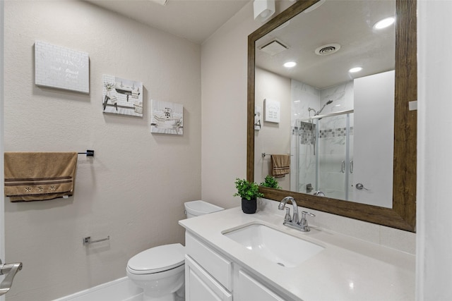 bathroom featuring vanity, a stall shower, visible vents, and toilet