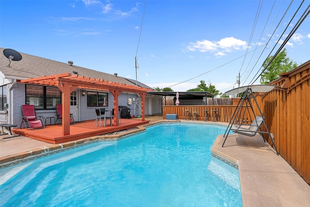 view of pool featuring a deck, outdoor dry bar, a fenced in pool, fence, and a pergola