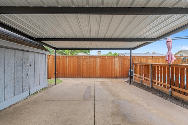 view of patio with a fenced backyard and a carport