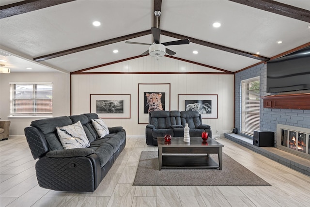 living area featuring a brick fireplace, ceiling fan, and lofted ceiling with beams