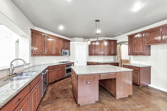 kitchen featuring a sink, light stone counters, a kitchen island, and stainless steel appliances