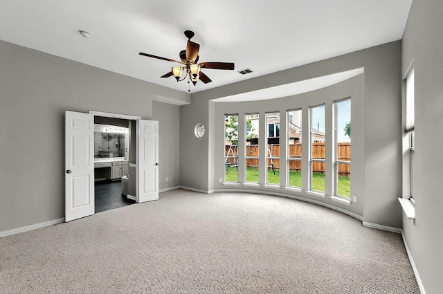 carpeted spare room featuring baseboards and a wealth of natural light