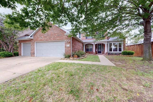 single story home featuring fence, an attached garage, a front lawn, brick siding, and concrete driveway