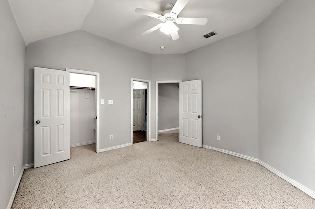 unfurnished bedroom featuring visible vents, carpet flooring, baseboards, and lofted ceiling
