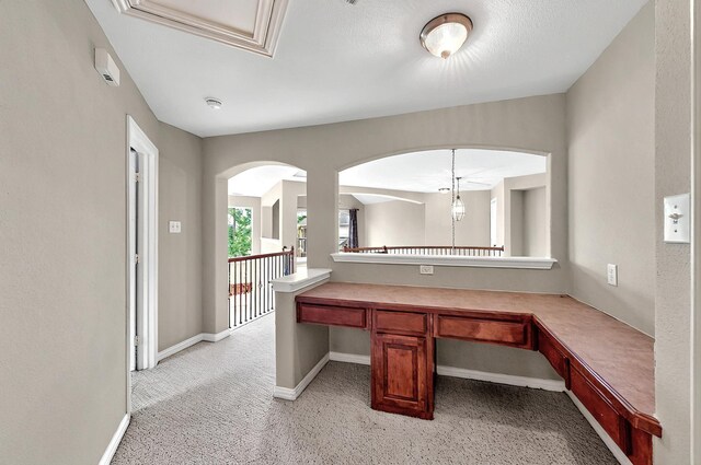 interior space with baseboards and light carpet