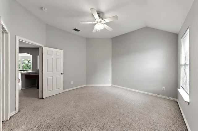 unfurnished bedroom featuring baseboards, lofted ceiling, and visible vents
