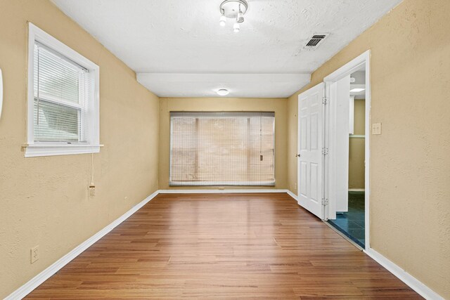 4416 Surrey St, Fort Worth, TX 76133 - corridor with wood finished floors, baseboards, and a textured wall