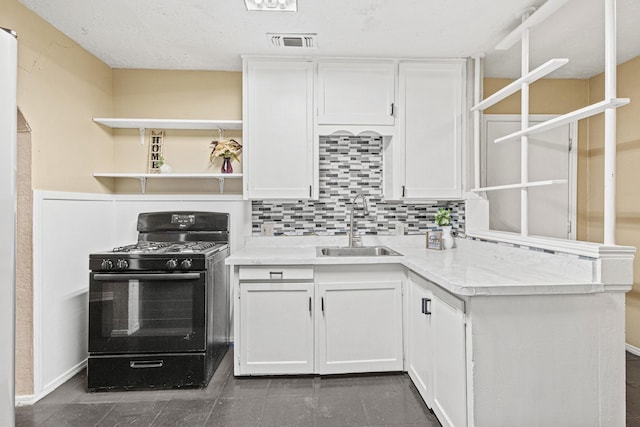 4416 Surrey St, Fort Worth, TX 76133 - kitchen featuring black gas range oven, a sink, open shelves, white cabinetry, and tasteful backsplash