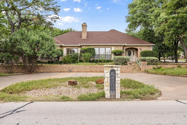 5311 Country Club Dr, Granbury, TX 76049 - view of front of property with a chimney, driveway, and a shingled roof