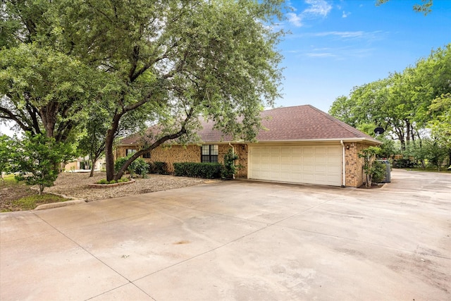 5311 Country Club Dr, Granbury, TX 76049 - view of front of property featuring brick siding, an attached garage, driveway, and roof with shingles