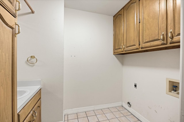 5311 Country Club Dr, Granbury, TX 76049 - laundry area featuring light tile patterned floors, hookup for an electric dryer, washer hookup, and cabinet space