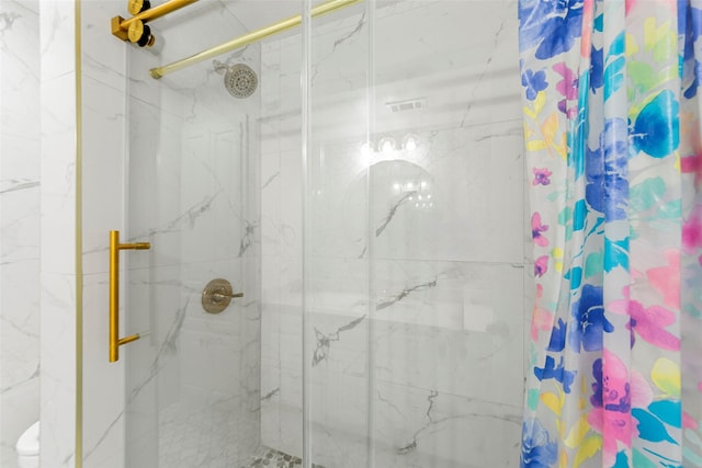 full bathroom featuring a marble finish shower